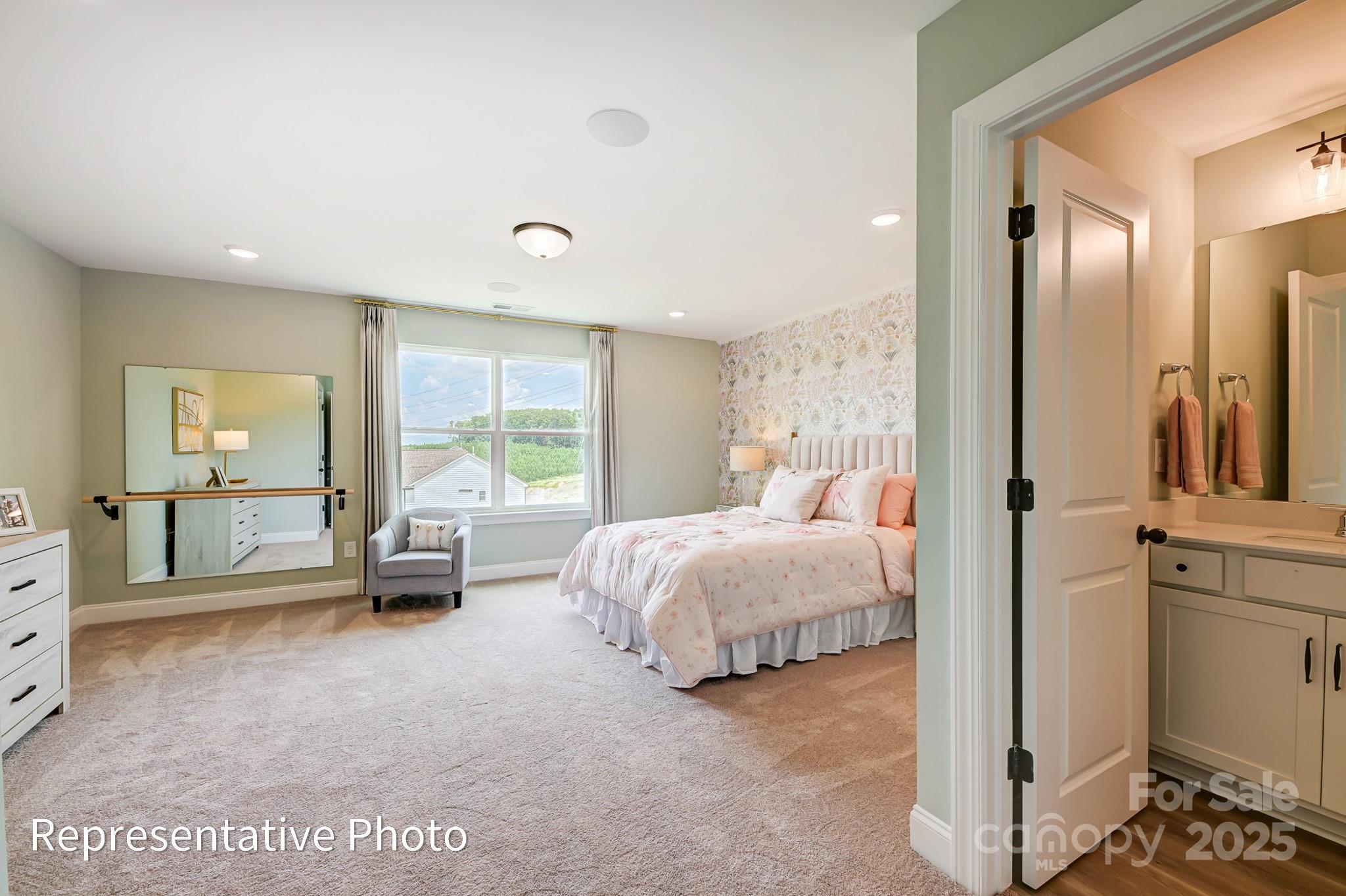 5038 Mclaughlin Loop Waxhaw, NC 28173 - Photo 24 of 25 a spacious bedroom with a bed and large windows