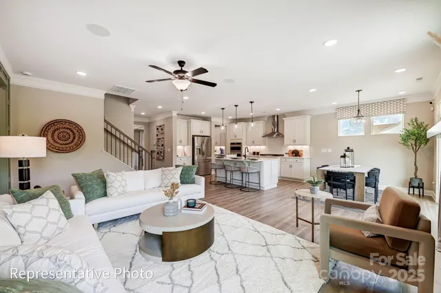 a living room with furniture kitchen view and a table