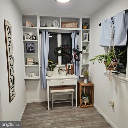 a view of living room with furniture and wooden floor