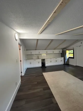 a white kitchen with a stove top oven