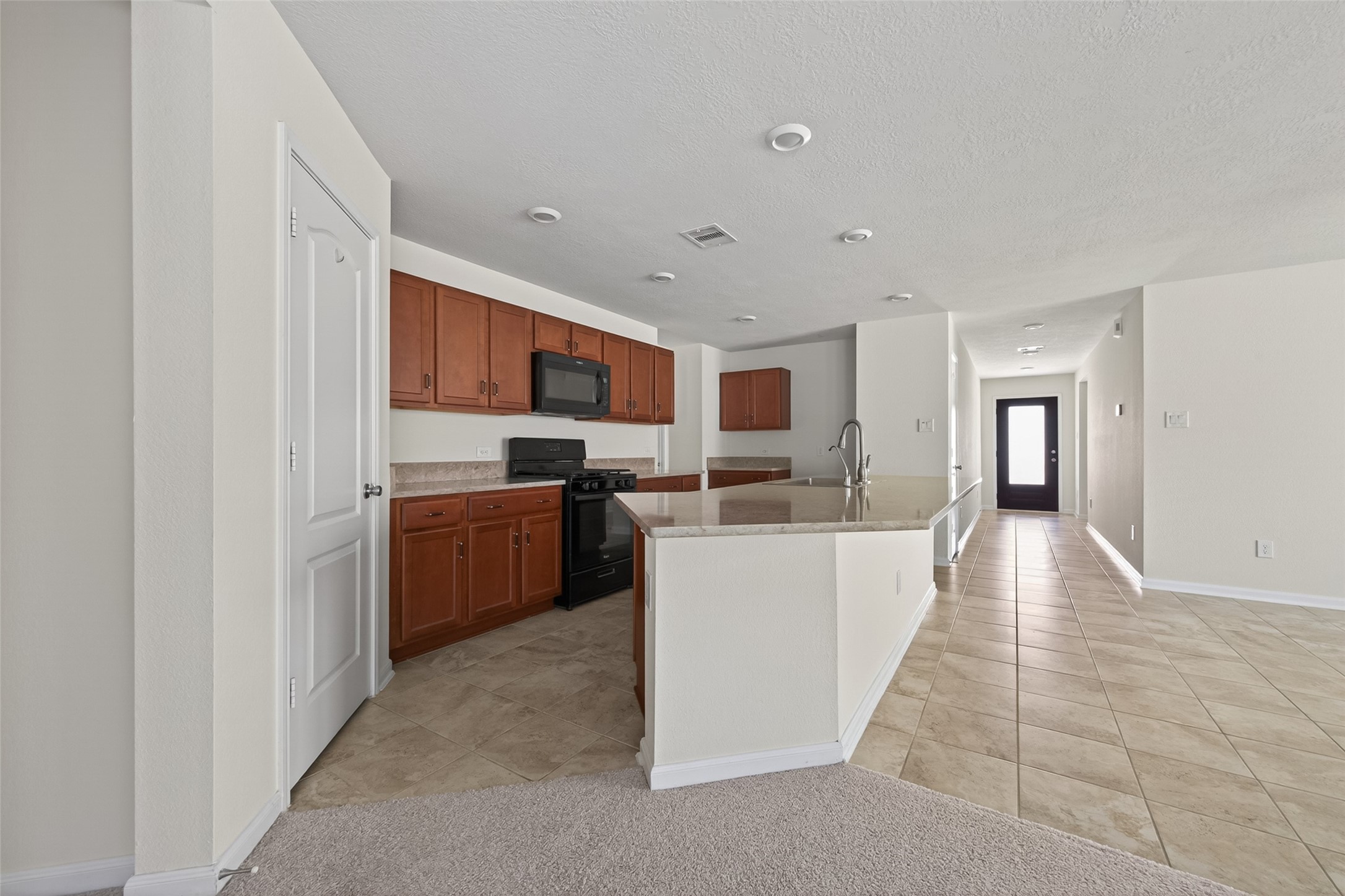 2754 Cayden Creek Way Conroe, TX 77304 - Photo 12 of 40 a kitchen with stainless steel appliances a refrigerator and a stove top oven