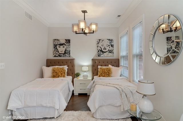 319 East 18th Street Chicago, IL 60616 - Photo 13 of 17 a bedroom with a bed and wall painting