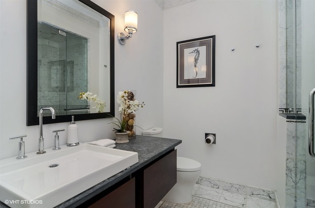 319 East 18th Street Chicago, IL 60616 - Photo 16 of 17 a bathroom with a granite countertop sink a toilet and mirror