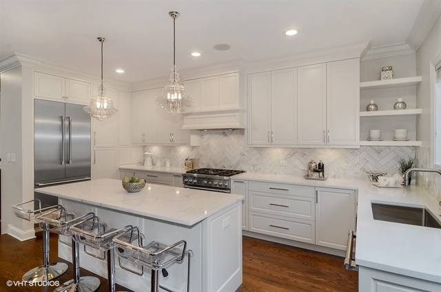 319 East 18th Street Chicago, IL 60616 - Photo 5 of 17 a kitchen with a sink a stove a refrigerator and white cabinets