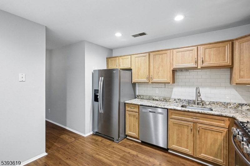 66 Whisper Way East Ledgewood, NJ 07852 - Photo 13 of 38 a kitchen with stainless steel appliances granite countertop a refrigerator sink and cabinets