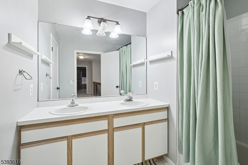 66 Whisper Way East Ledgewood, NJ 07852 - Photo 15 of 38 a bathroom with a double vanity sink and a mirror