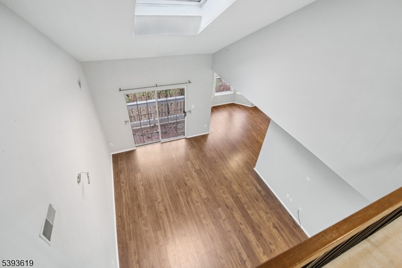 66 Whisper Way East Ledgewood, NJ 07852 - Photo 16 of 38 a view of an empty room with wooden floor and a window