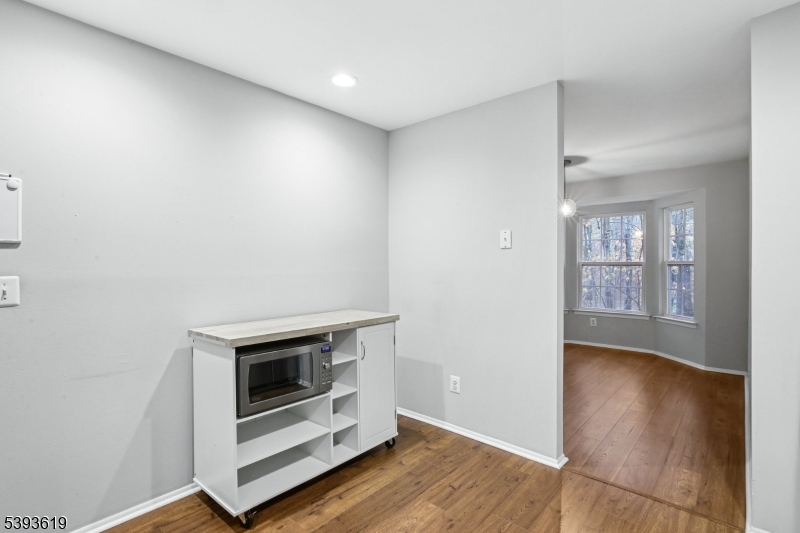 66 Whisper Way East Ledgewood, NJ 07852 - Photo 19 of 38 a view of an empty room with wooden floor and a window
