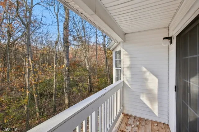 a view of a balcony with wooden floor and fence
