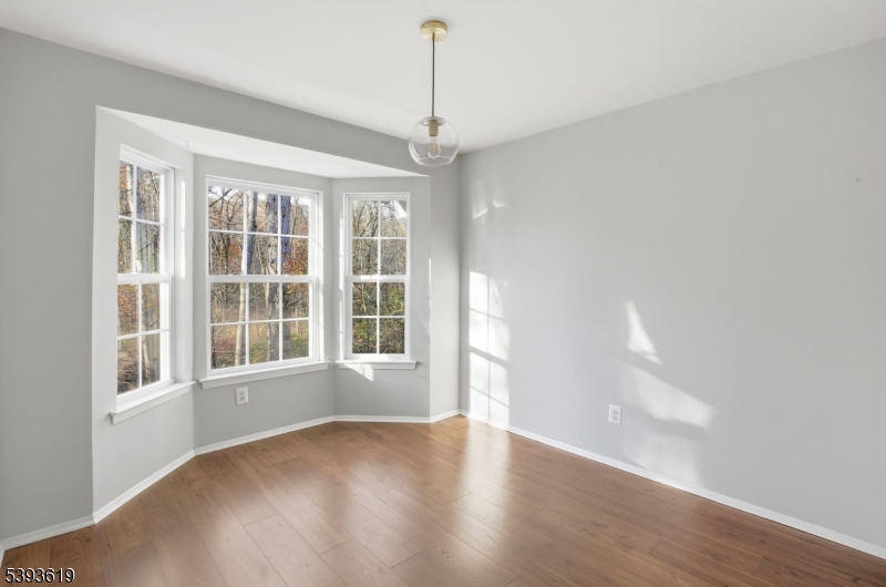 66 Whisper Way East Ledgewood, NJ 07852 - Photo 38 of 38 a view of an empty room with a window and wooden floor