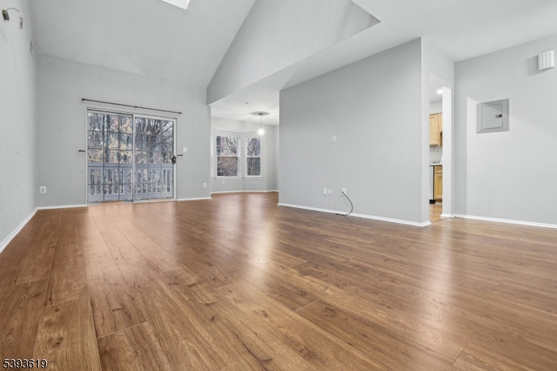 66 Whisper Way East Ledgewood, NJ 07852 - Photo 5 of 38 a view of an empty room with wooden floor and a window