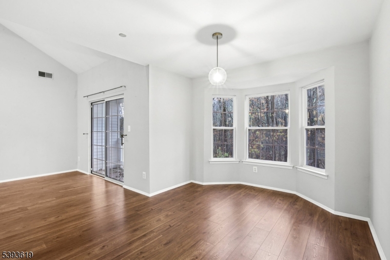 66 Whisper Way East Ledgewood, NJ 07852 - Photo 7 of 38 a view of an empty room with a window and wooden floor