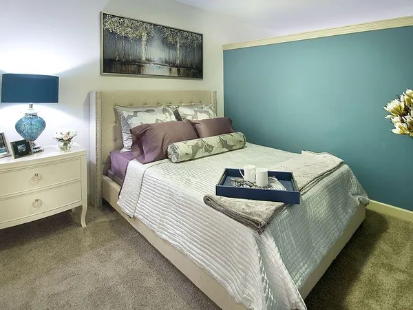 a bedroom with a bed and a night stand