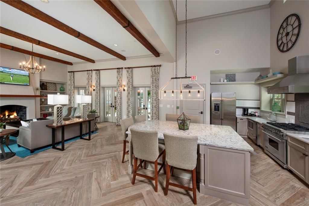 2420 Peachtree Road Northwest, Unit 1205 Atlanta, GA 30305 - Photo 17 of 39 a large kitchen with a table and chairs