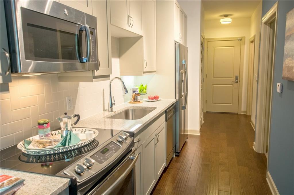 2420 Peachtree Road Northwest, Unit 1205 Atlanta, GA 30305 - Photo 2 of 39 a kitchen with a sink and a refrigerator