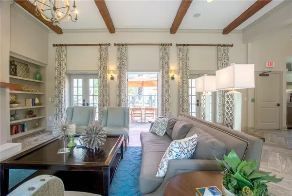 a living room with furniture and a book shelf