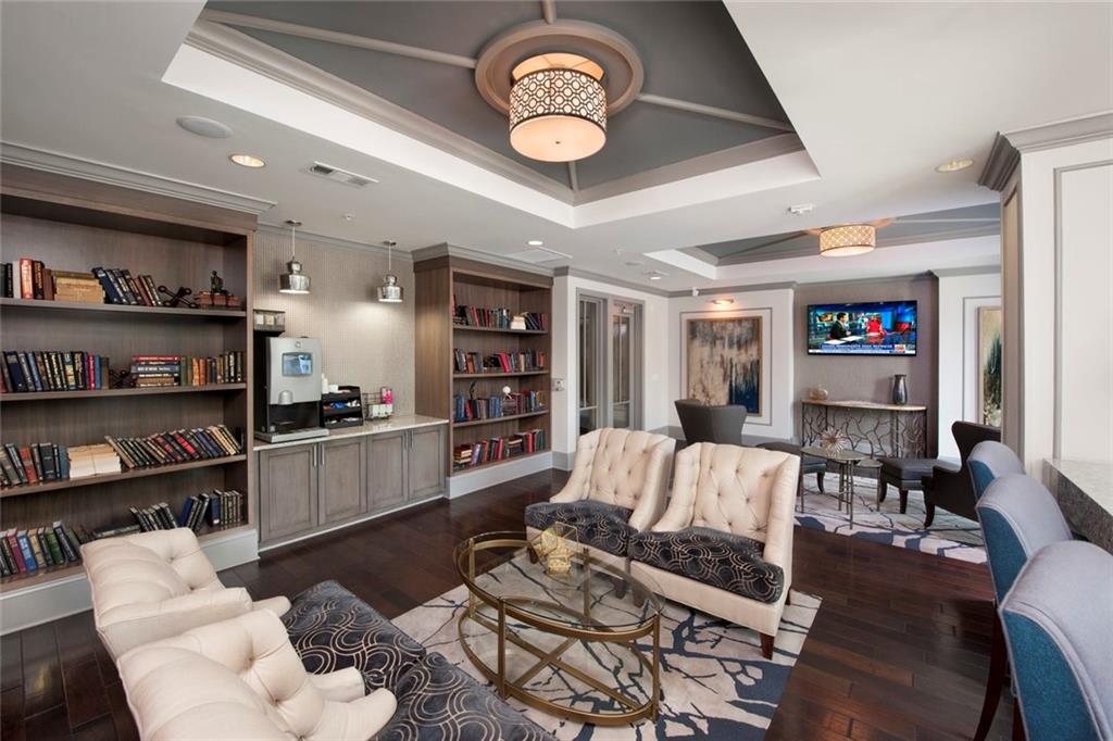 2420 Peachtree Road Northwest, Unit 1205 Atlanta, GA 30305 - Photo 30 of 39 a living room with furniture and a book shelf