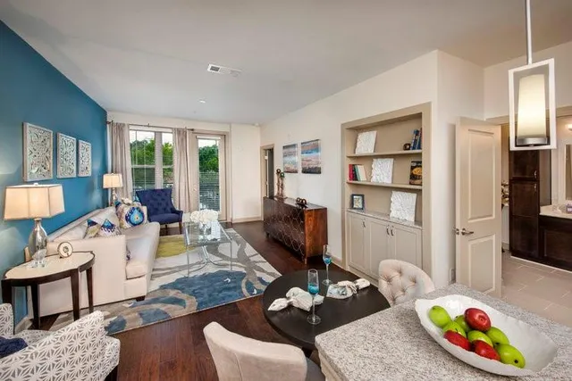 a living room with furniture fireplace and a window