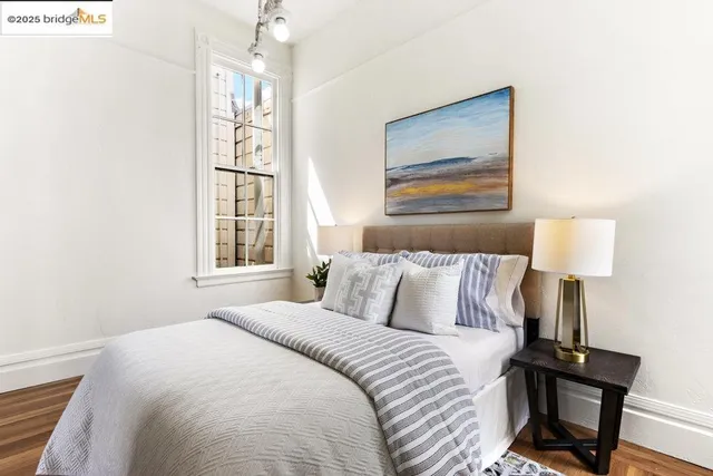 a bedroom with a bed and a window