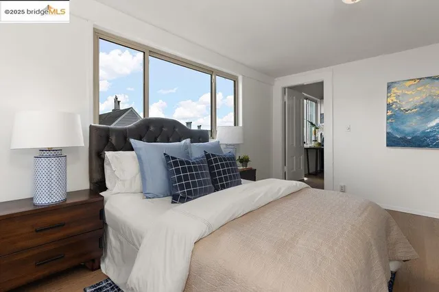 a bedroom with a large bed and a large window