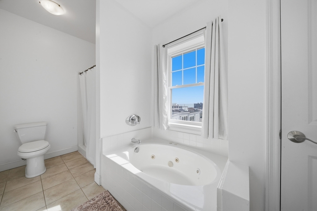 233 Beach Road, Unit A11 Salisbury, MA 01952 - Photo 27 of 37 a bathroom with a bathtub sink and toilet