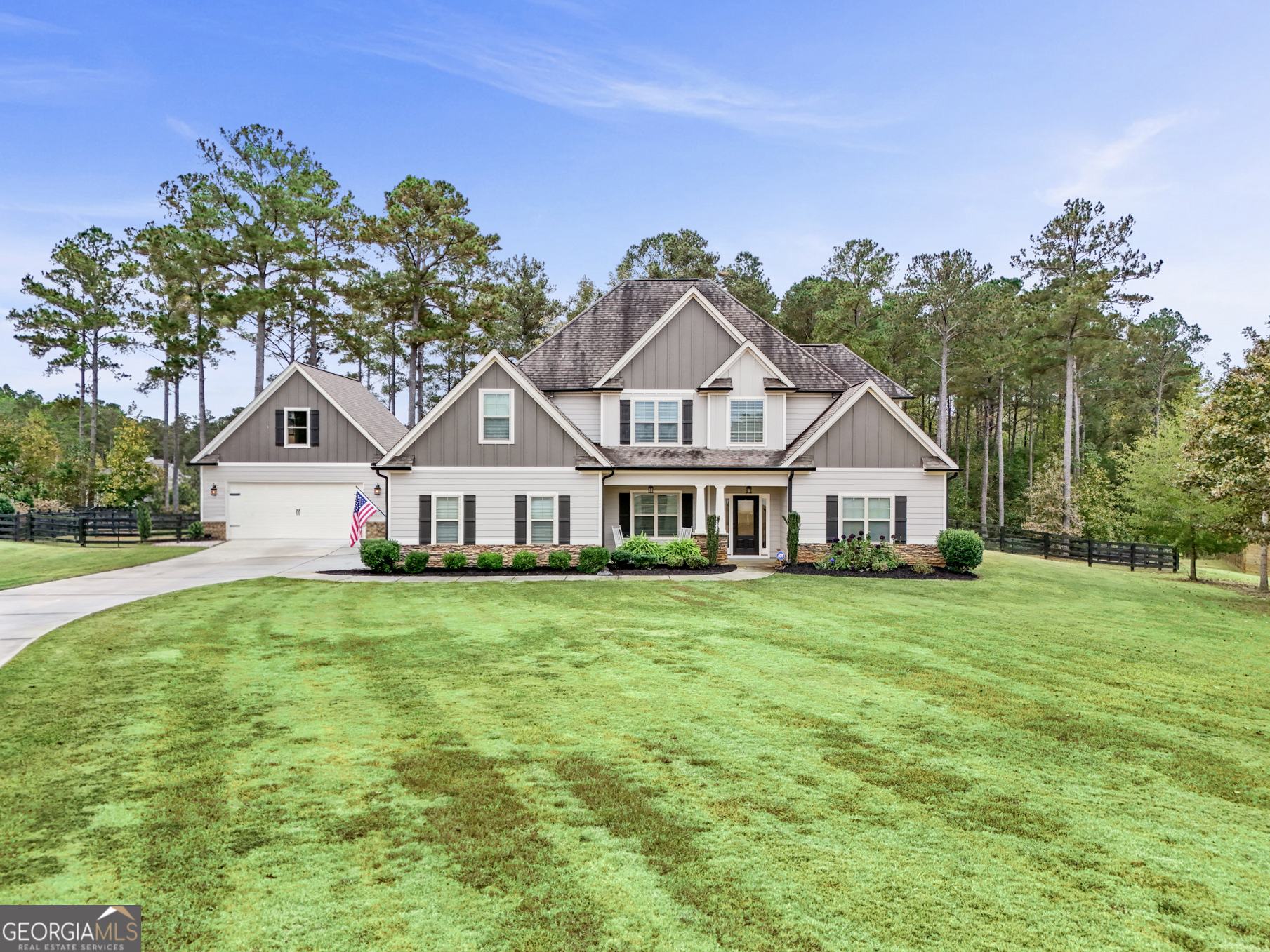 a front view of a house with a garden
