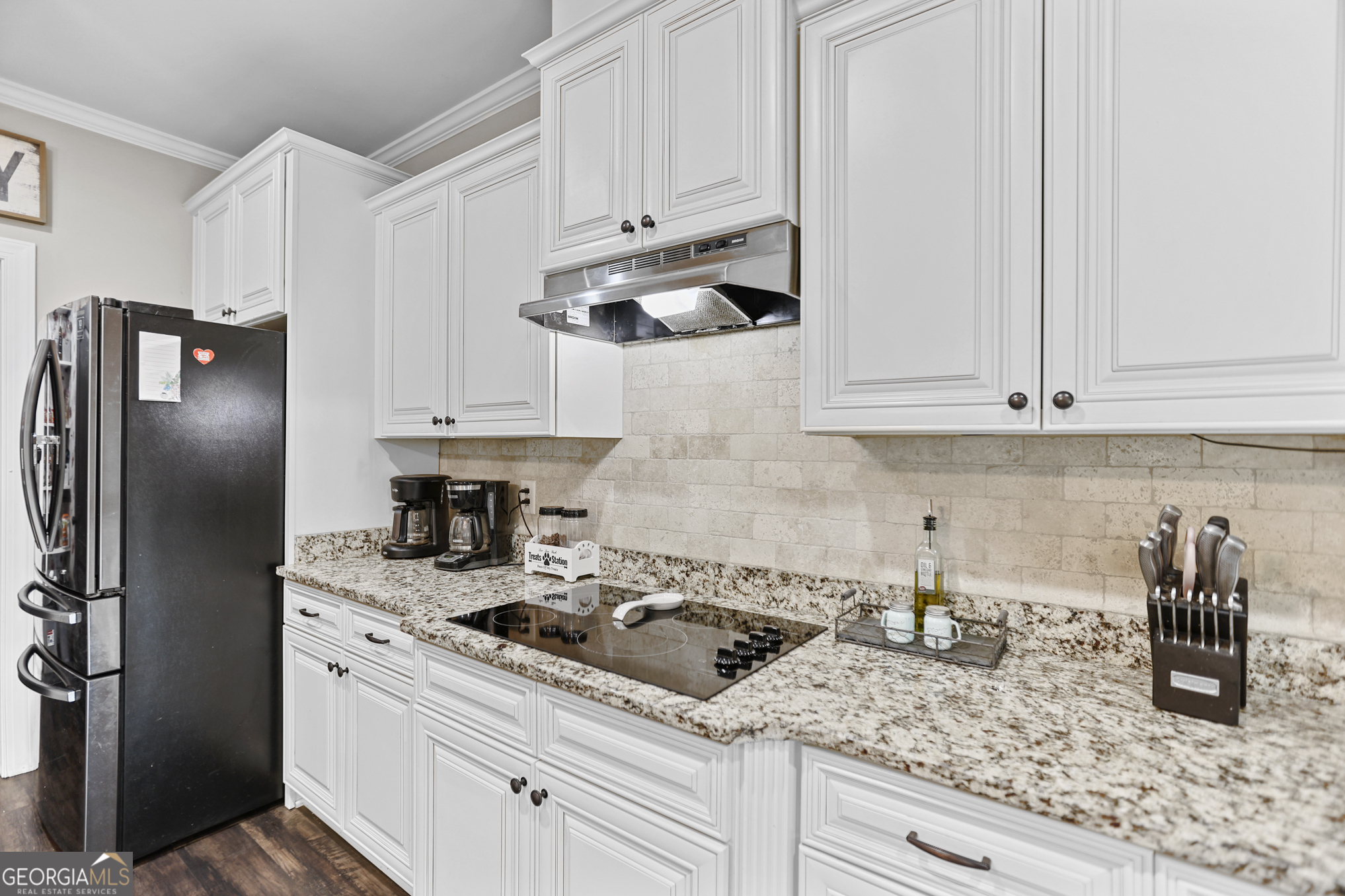 22 Huntsman Run Senoia, GA 30276 - Photo 25 of 69 a kitchen with stainless steel appliances granite countertop white cabinets and a stove