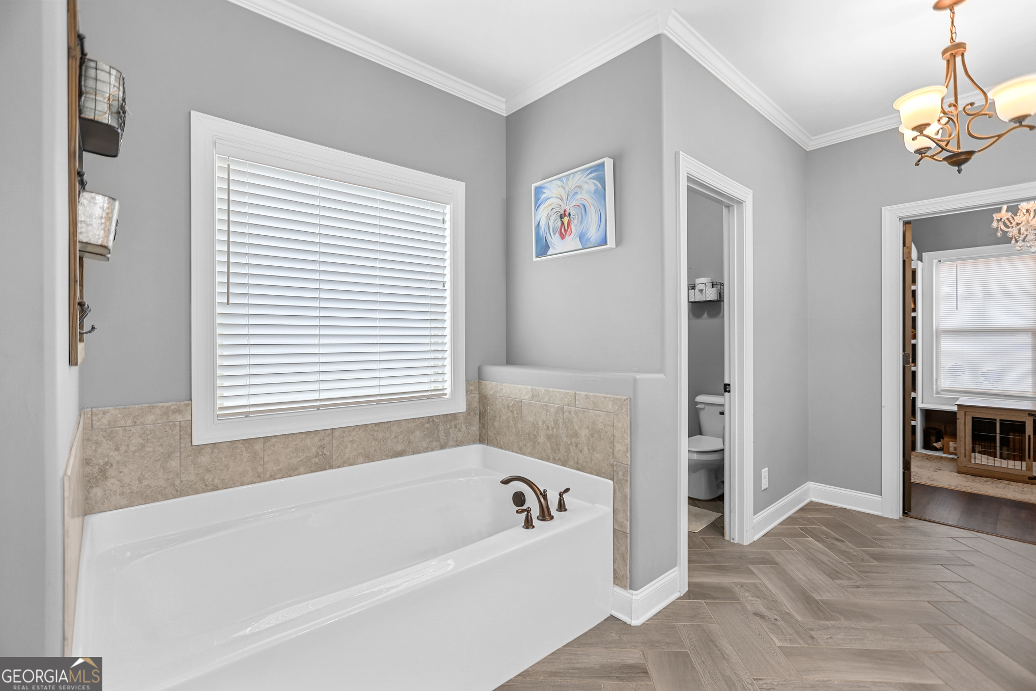 22 Huntsman Run Senoia, GA 30276 - Photo 39 of 69 a bathroom with a bathtub and a chandelier