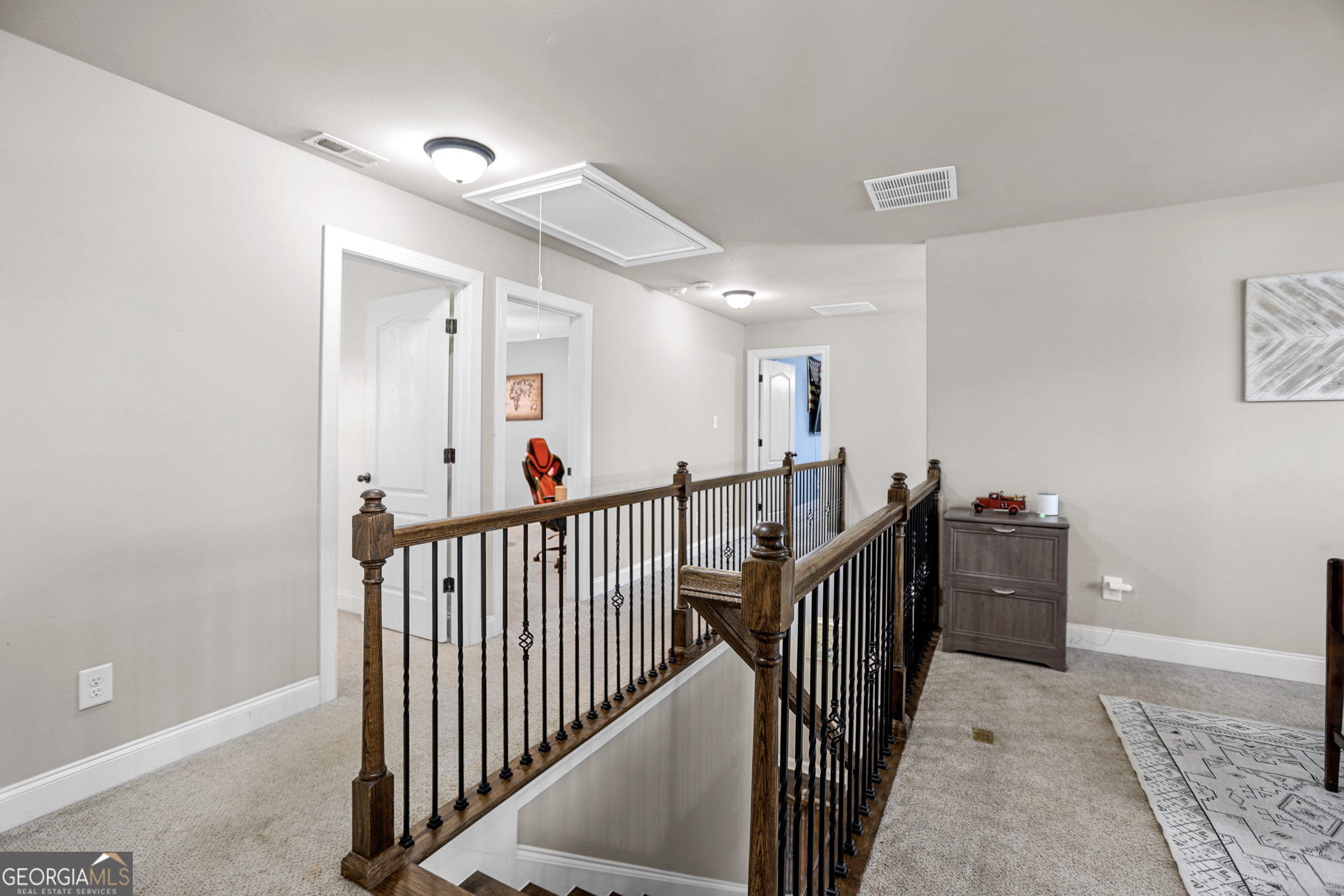 22 Huntsman Run Senoia, GA 30276 - Photo 50 of 69 a view of a hallway with wooden floor and stairs