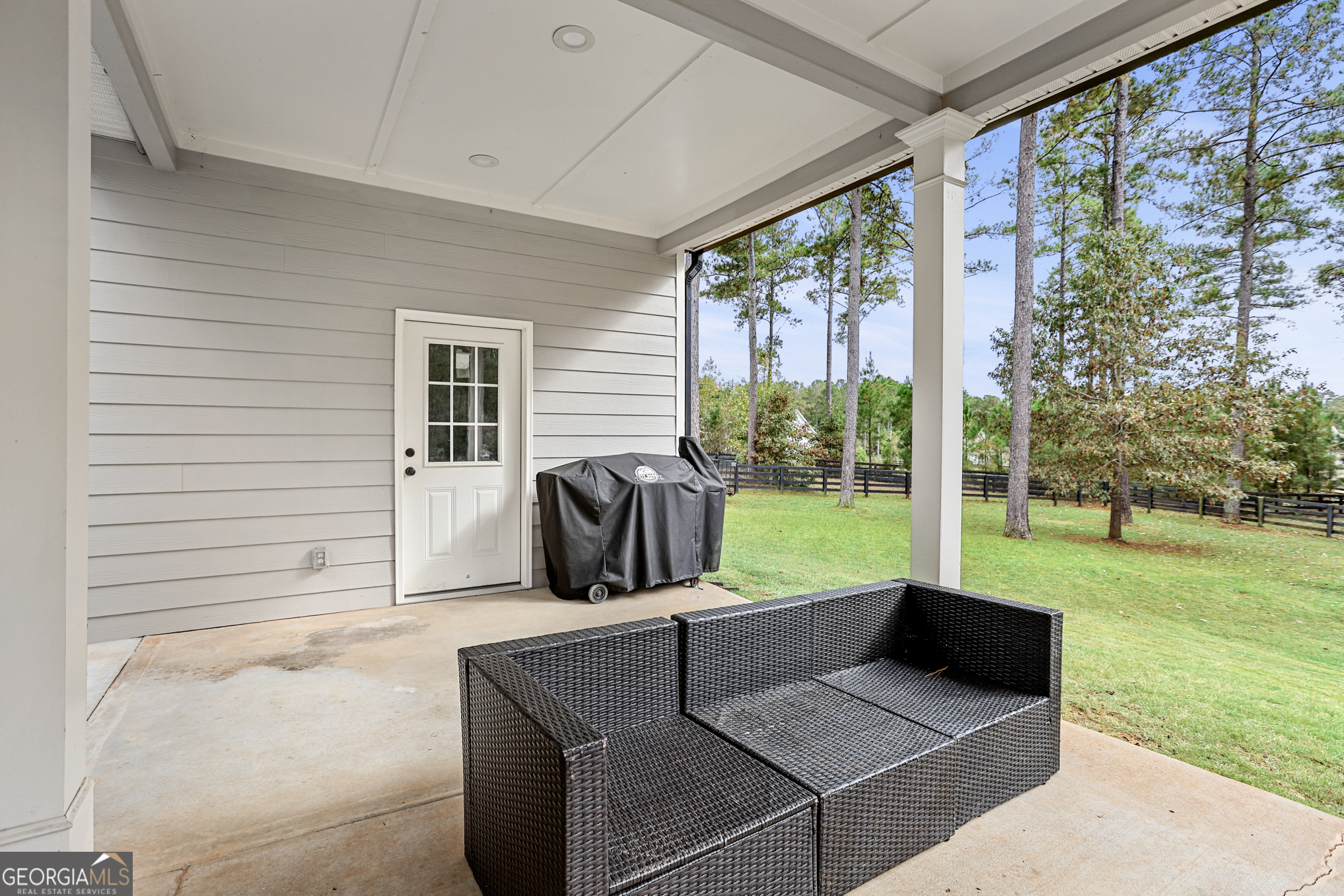 22 Huntsman Run Senoia, GA 30276 - Photo 61 of 69 a view of a patio with a table chairs and a backyard