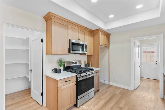 a kitchen with stainless steel appliances a white stove top oven and a refrigerator
