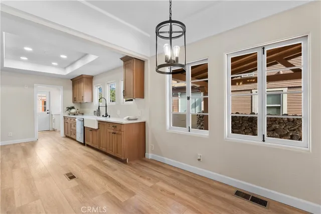 a large white kitchen with granite countertop a large counter space and stainless steel appliances