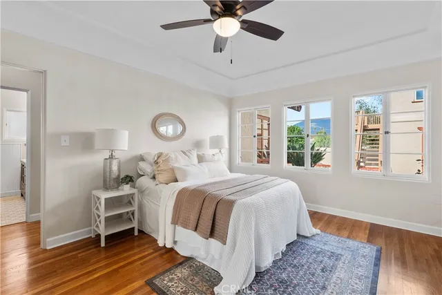 a bedroom with a large bed and a chandelier