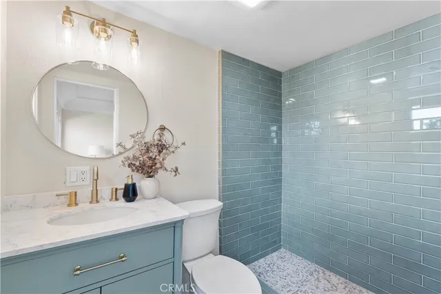 a bathroom with a toilet a sink and mirror