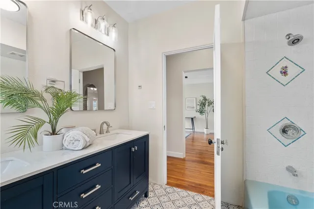a bathroom with a sink vanity granite and a mirror