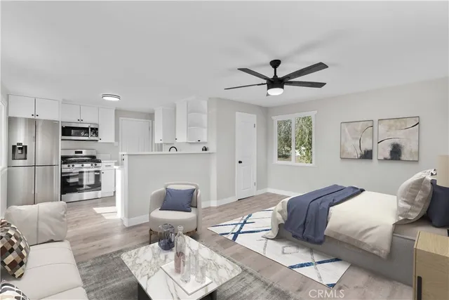 a kitchen with a sink cabinets and wooden floor