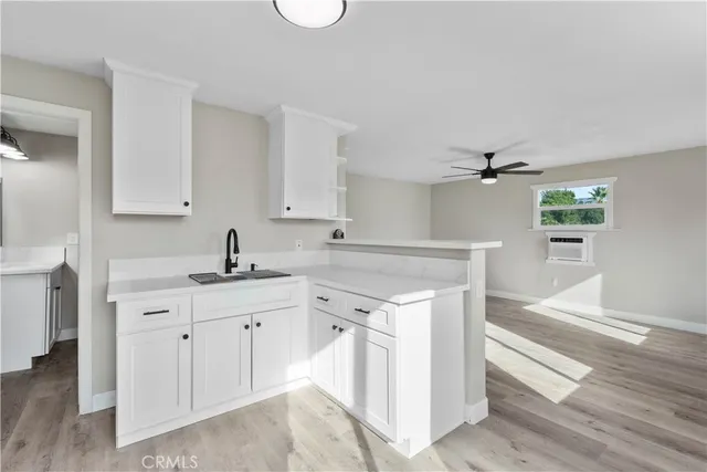 a view of a house with a yard and palm trees