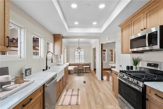 a large kitchen with stainless steel appliances granite countertop a lot of counter space and a sink