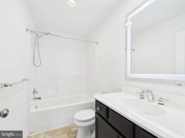 a bathroom with a sink toilet vanity and shower