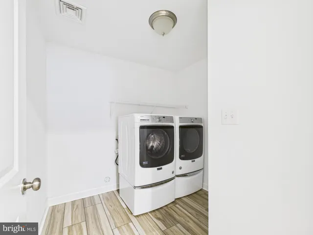 a utility room with washing machine