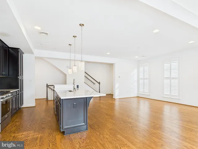 a spacious bathroom with a sink a mirror and shower