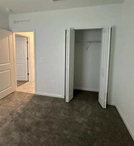 an empty room with closet area