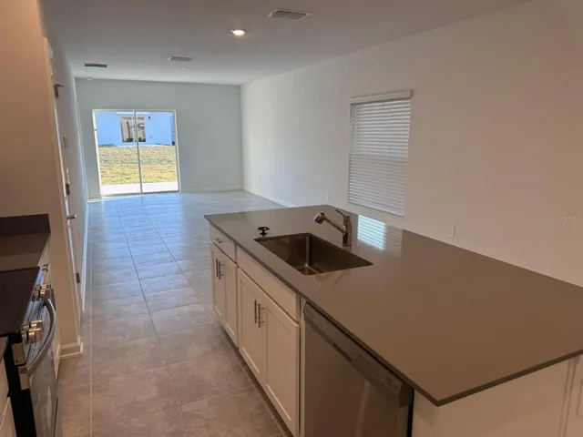 a kitchen that has a sink and a stove