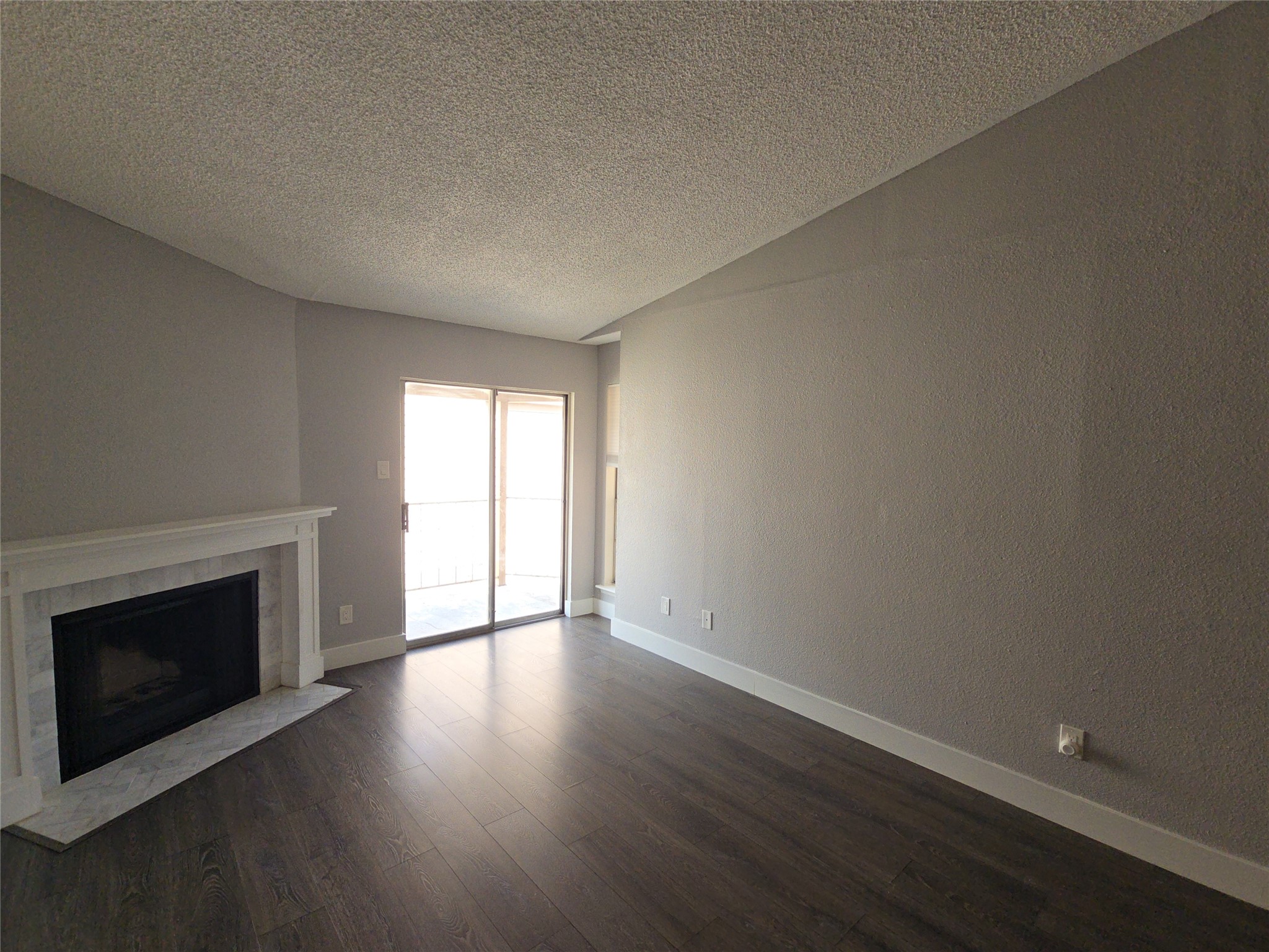 10101 South Gessner Road, Unit 708 Houston, TX 77071 - Photo 12 of 20 an empty room with wooden floor and fireplace