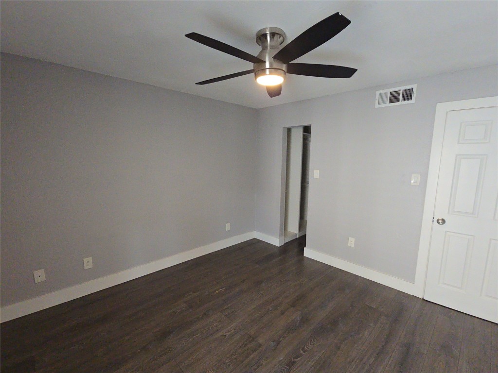 10101 South Gessner Road, Unit 708 Houston, TX 77071 - Photo 7 of 20 an empty room with wooden floor and a ceiling fan