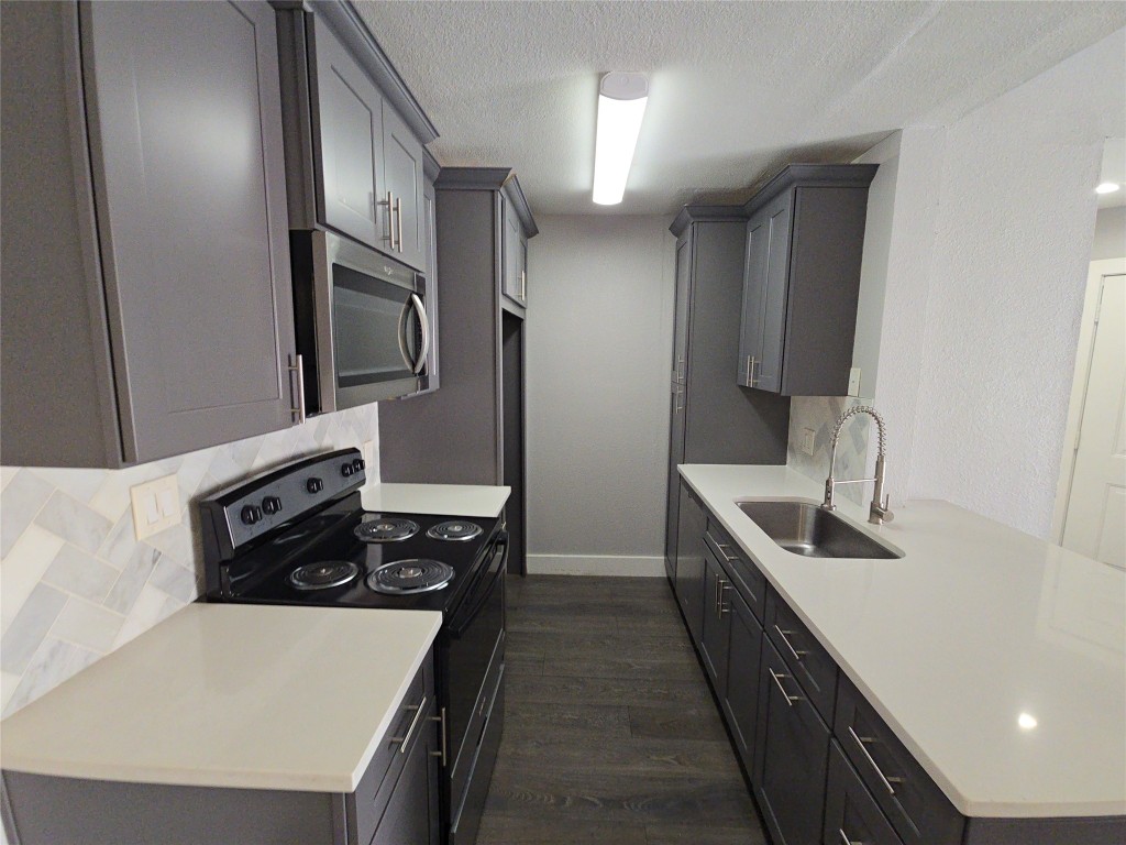 10101 South Gessner Road, Unit 708 Houston, TX 77071 - Photo 10 of 20 a kitchen with stainless steel appliances granite countertop a sink stove and refrigerator