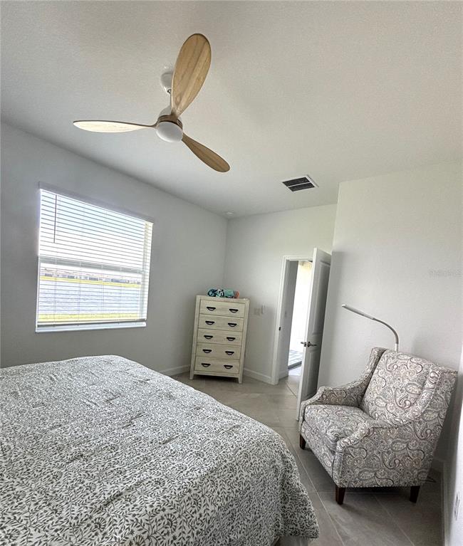 8787 St Kitts Circle Englewood, FL 34224 - Photo 13 of 29 a bedroom with a bed and a couch