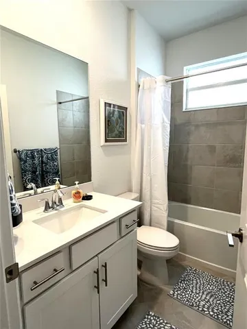 a bathroom with a sink toilet tub and shower