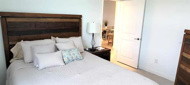 a bed room with a bed and a chair