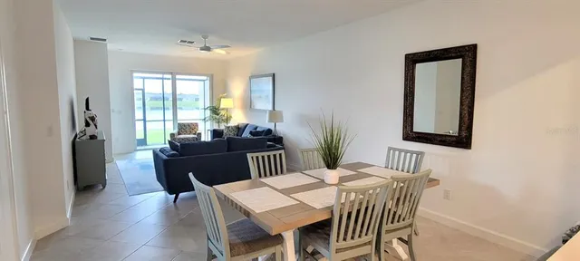 a view of a dining room with furniture and window
